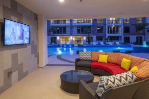 Apartments for rent in Sugar Land, TX - Outdoor Patio off the Pool Area with Seating and TV at Night