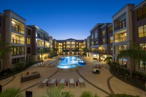 Apartment Rentals in Sugar Land, TX - Pool and Patio Area with Seating at Night