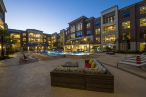Apartments for rent in Sugar Land, TX - Pool and Patio Area with Seating at Night